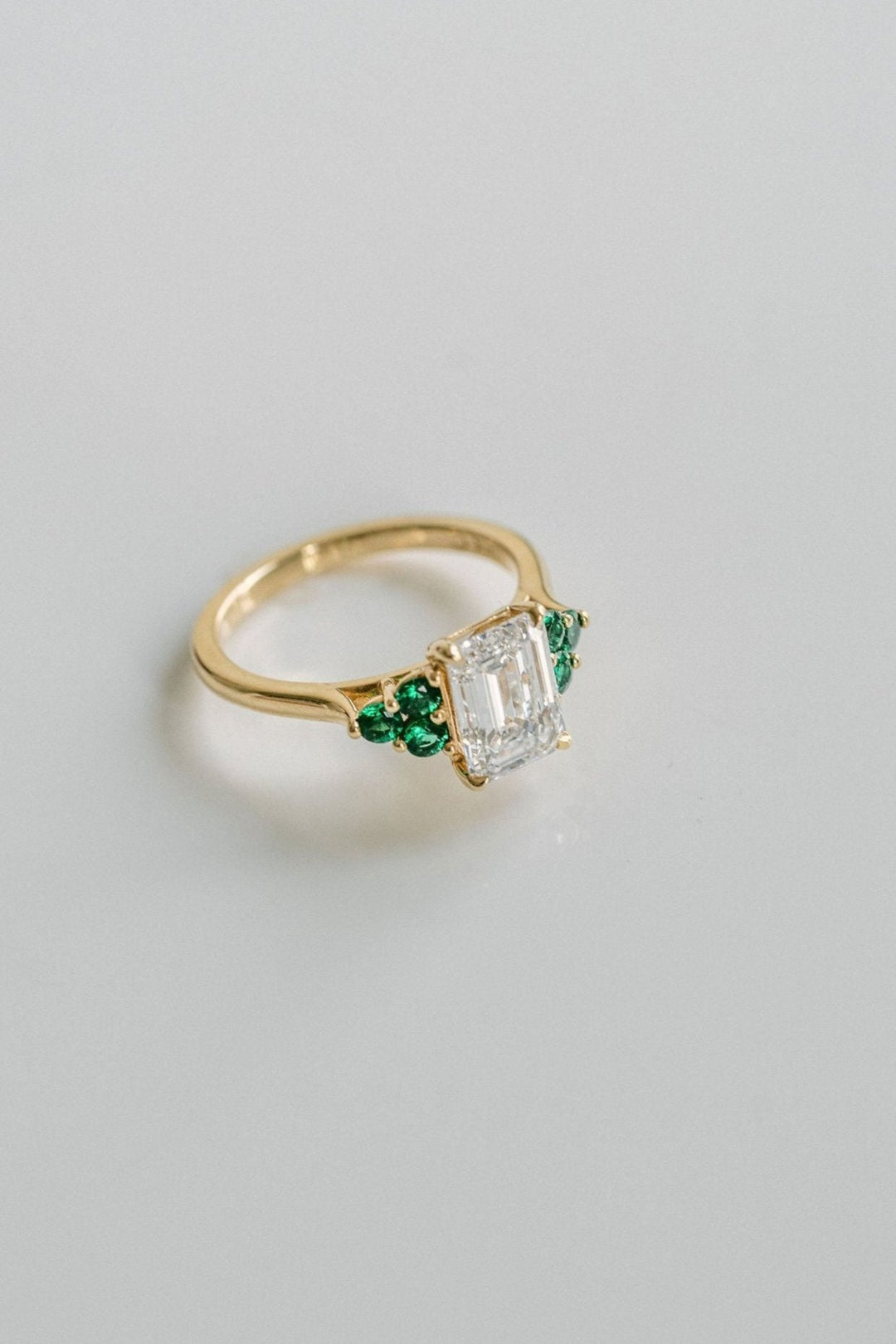 Emerald Cut Diamond With Emerald Cluster Accents