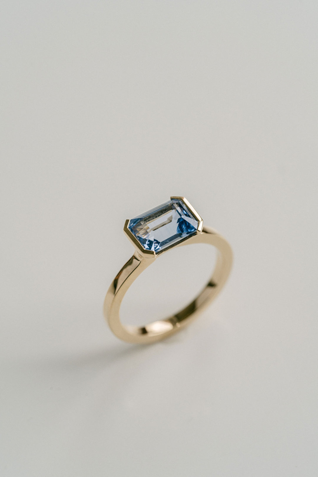 Emerald Cut Blue Sri Lankan Sapphire East-West Half Bezel, 14k Yellow Gold