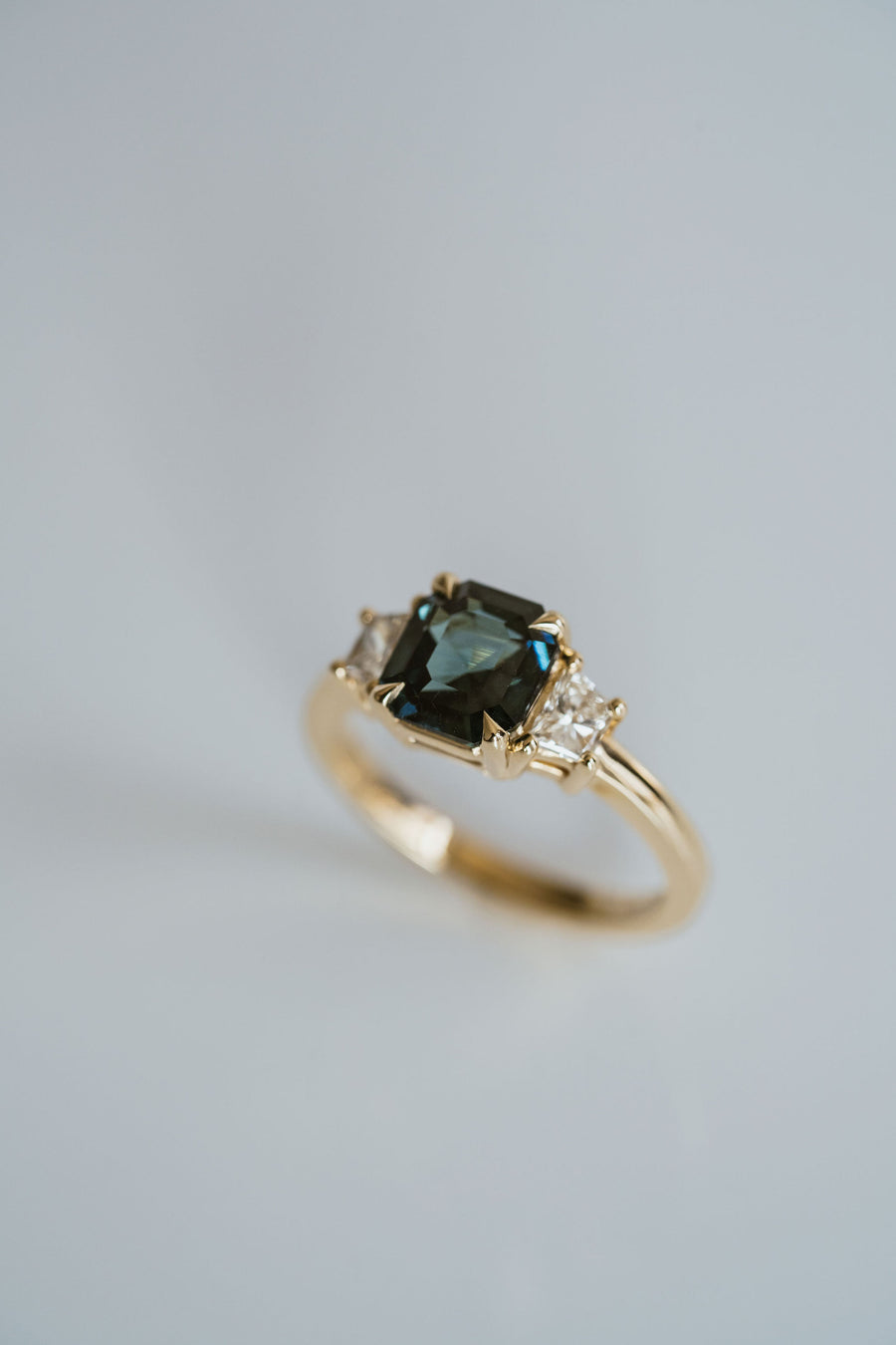 Square Emerald Cut Blue-Green Sapphire with Brilliant Trapezoid Diamond Accents