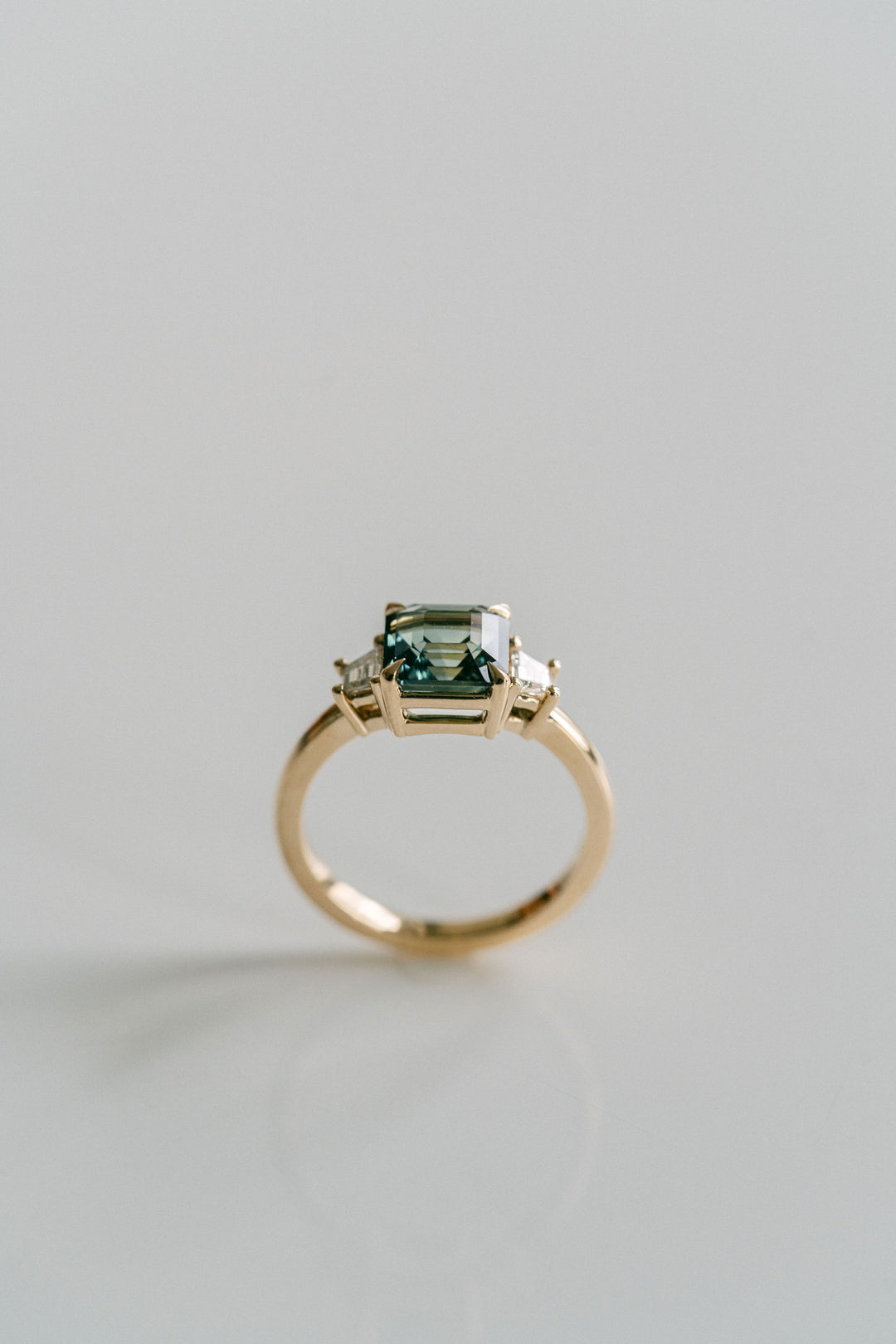 Square Emerald Cut Blue-Green Sapphire with Step Cut Trapezoid Diamond Accents