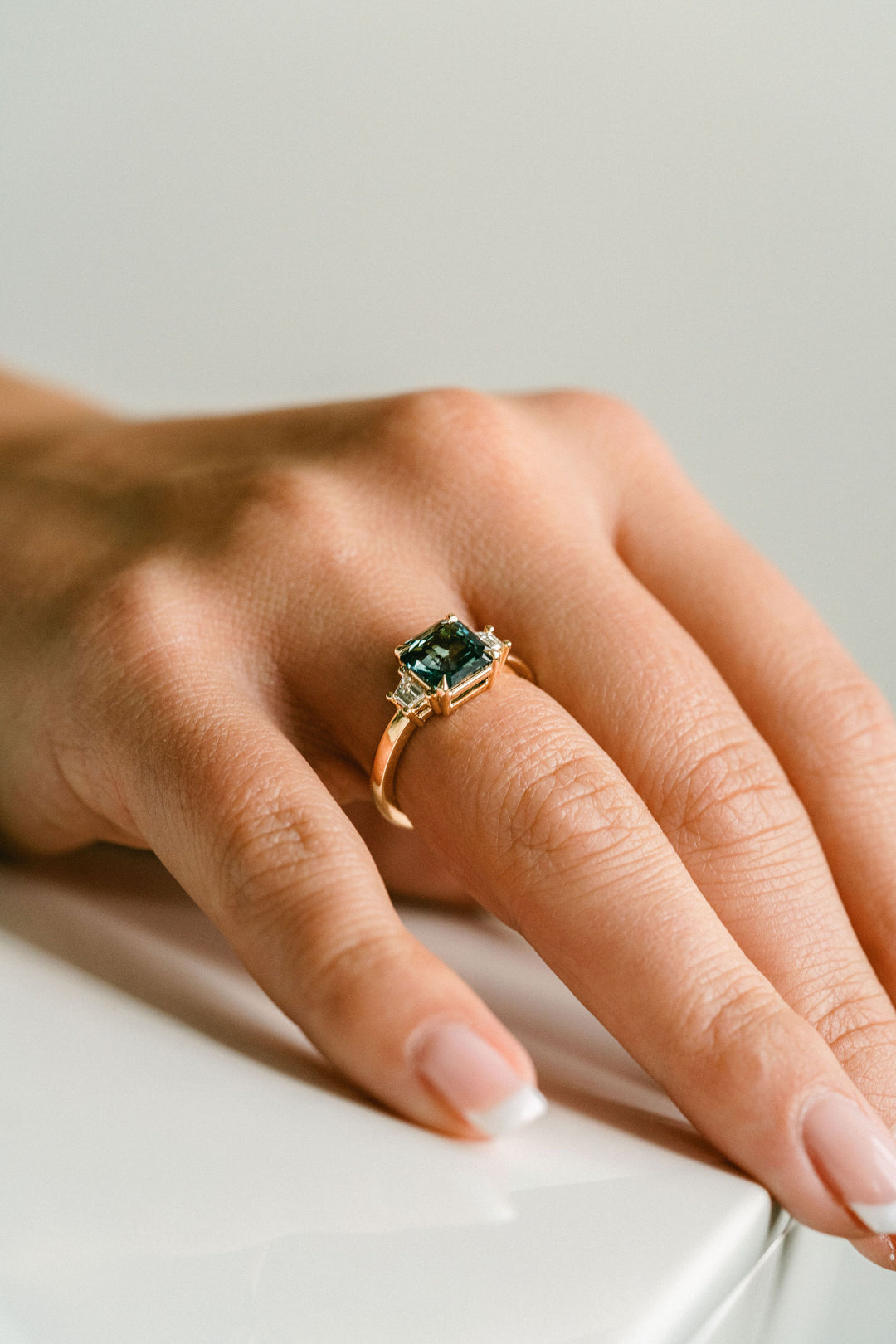 Square Emerald Cut Blue-Green Sapphire with Step Cut Trapezoid Diamond Accents