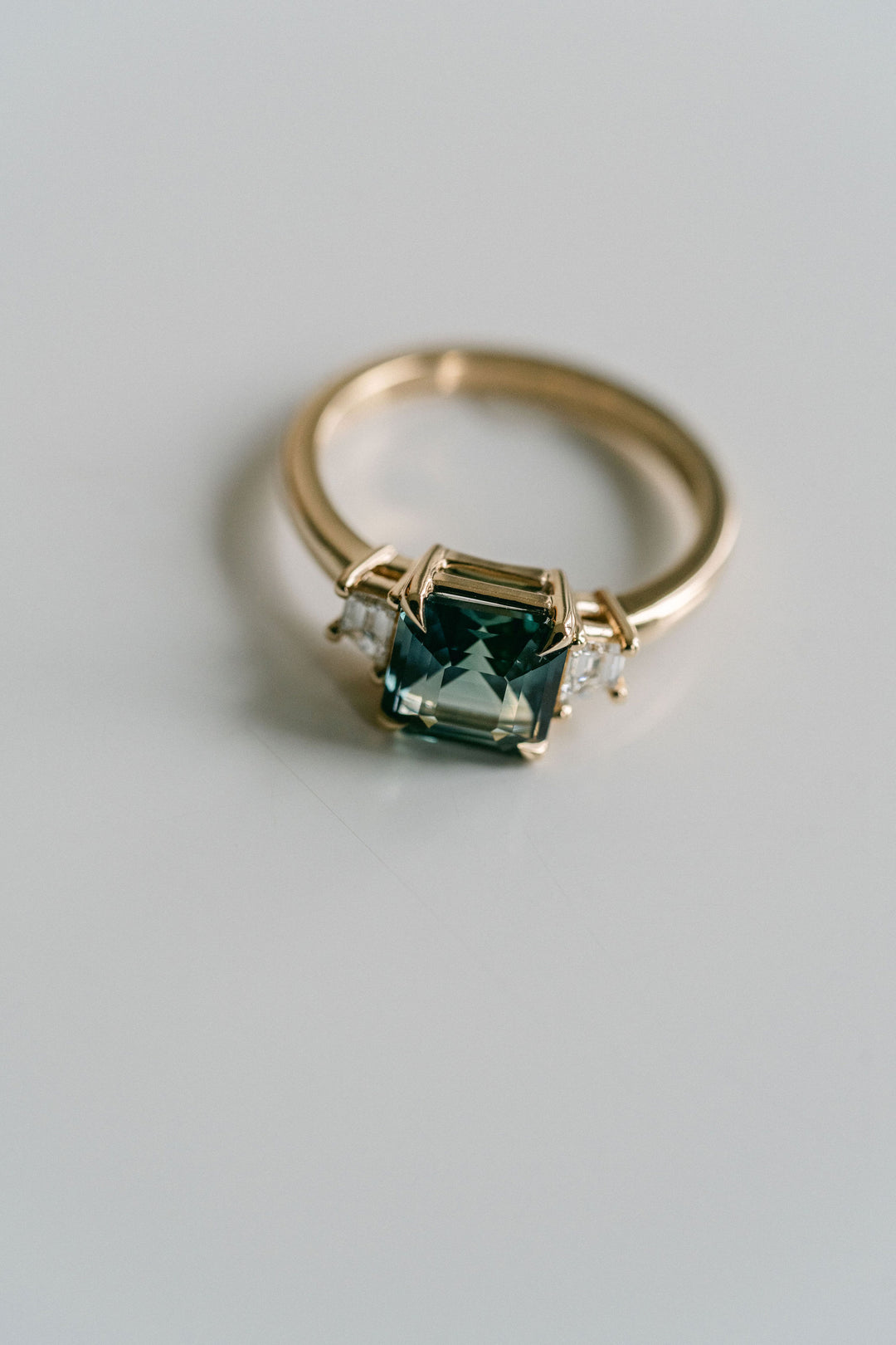 Square Emerald Cut Blue-Green Sapphire with Step Cut Trapezoid Diamond Accents