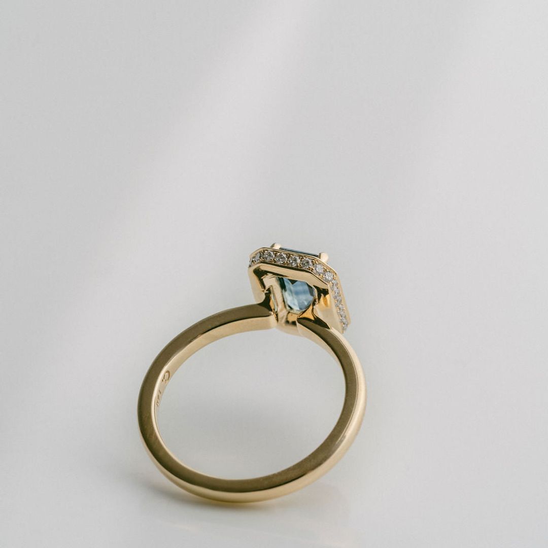 Emerald Cut Blue-Green Sapphire With Solid Gold Halo and Diamond Collar