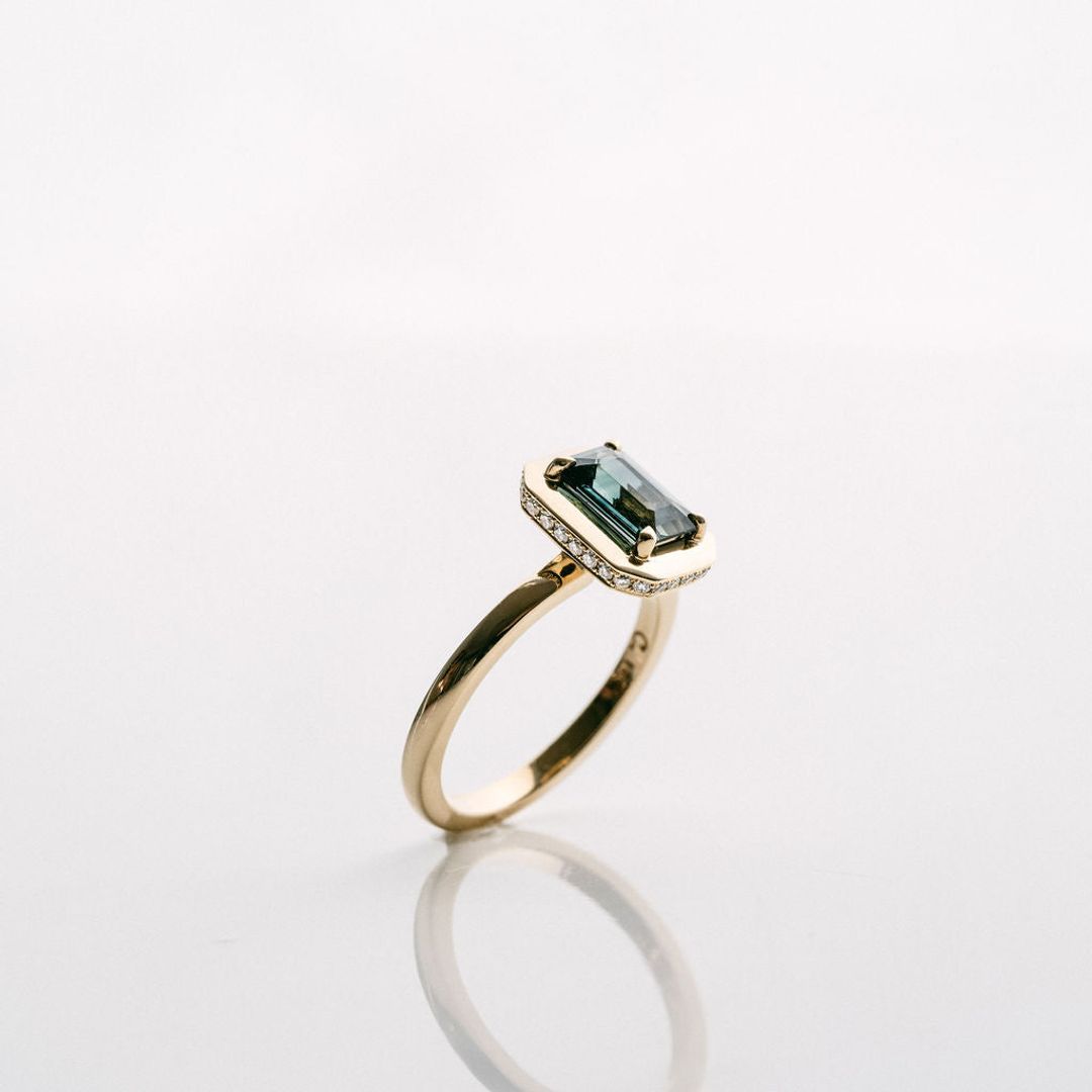 Emerald Cut Blue-Green Sapphire With Solid Gold Halo and Diamond Collar