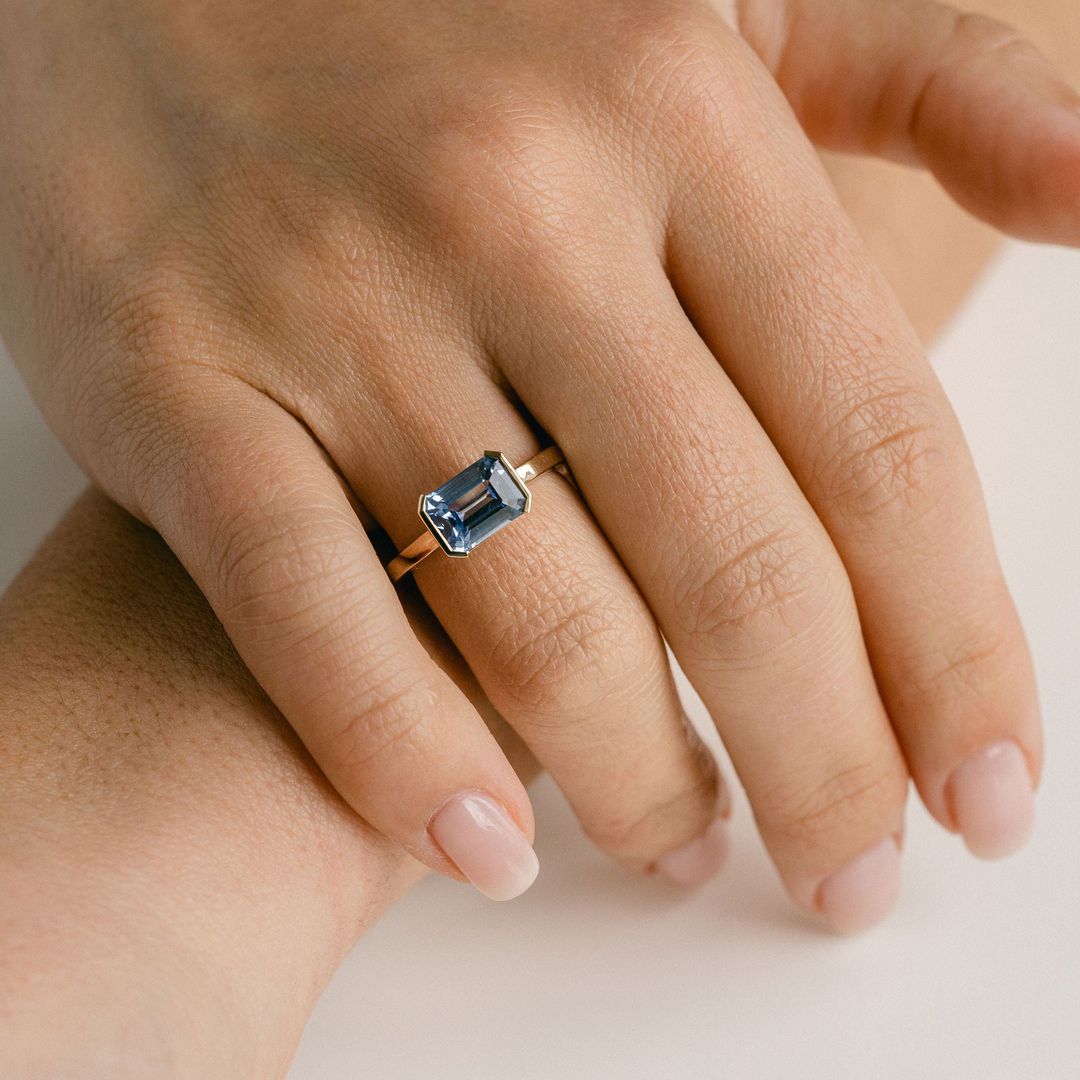 Emerald Cut Blue Sapphire East-West Half Bezel