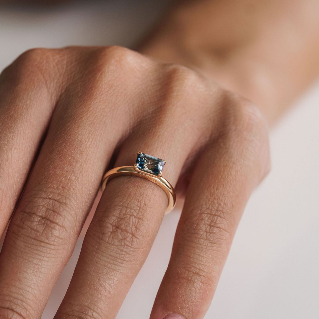 Emerald Cut East-West Blue Green Sapphire Solitaire