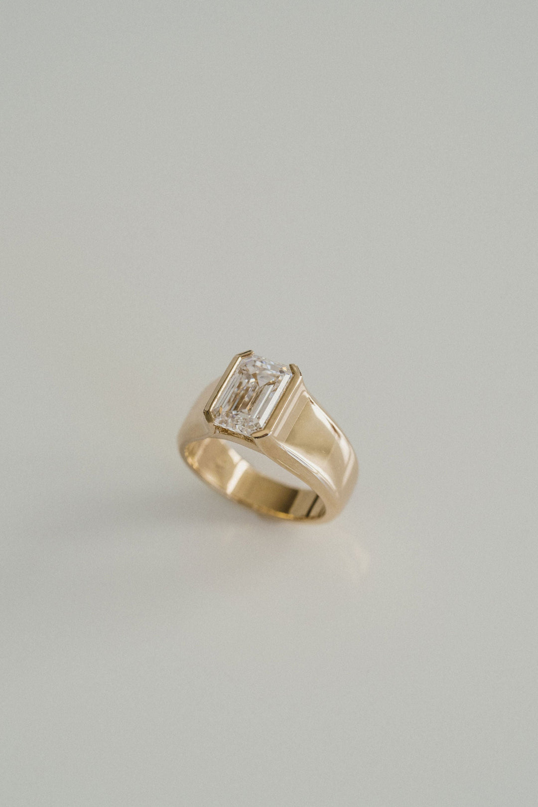 Emerald Cut Diamond Half Bezel Manor Ring
