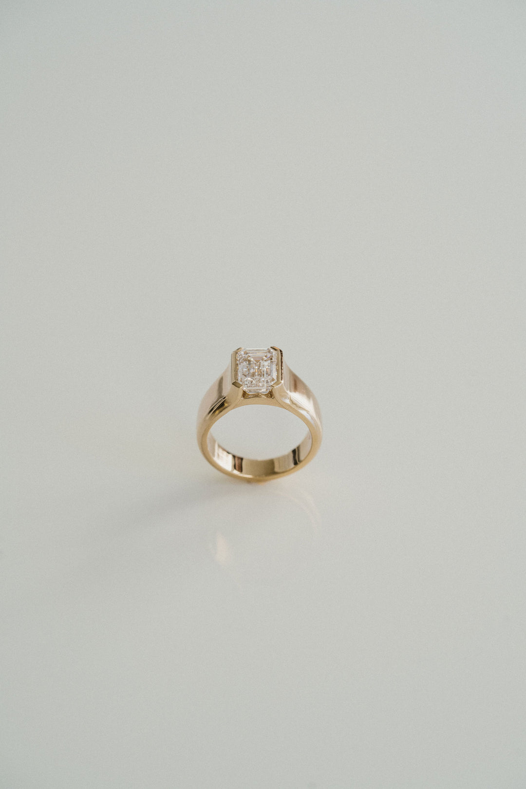 Emerald Cut Diamond Half Bezel Manor Ring