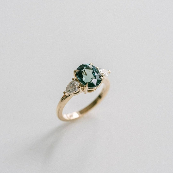 Oval Blue-Green Sapphire With Pear Shape Diamond Accents