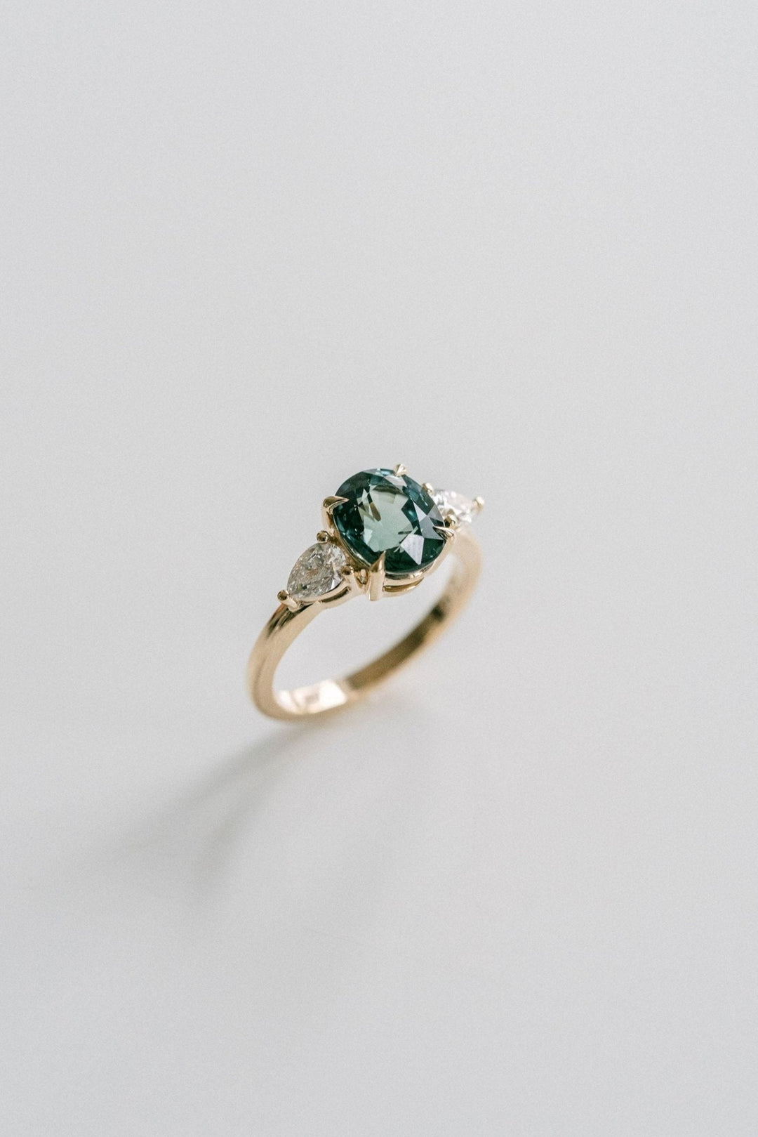 Oval Blue-Green Sapphire With Pear Shape Diamond Accents