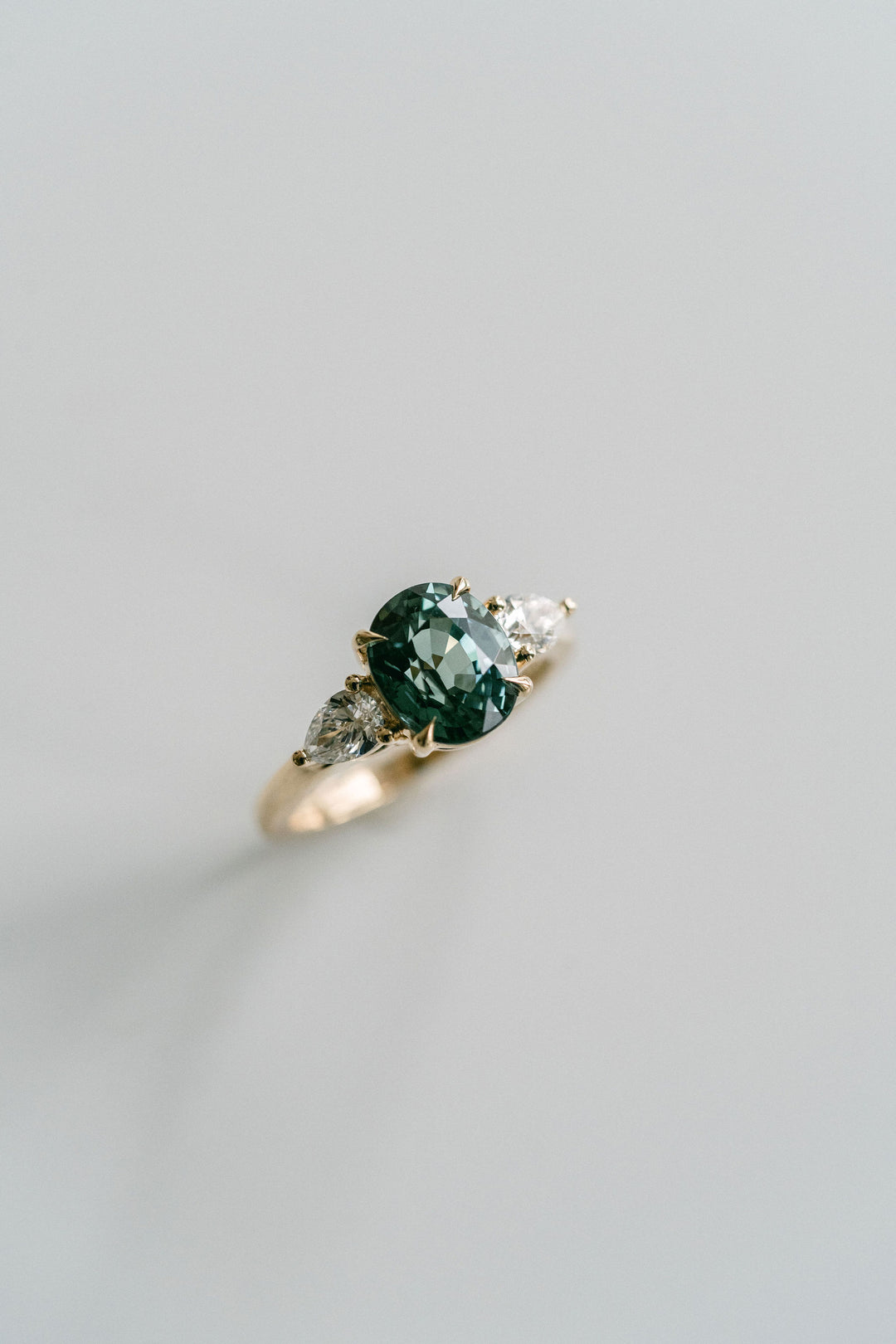 Oval Blue-Green Sapphire With Pear Shape Diamond Accents