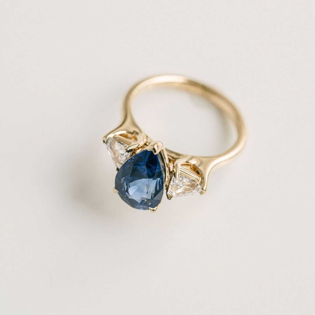 Pear Shape Blue Sapphire With Shield Shape Diamond Accents