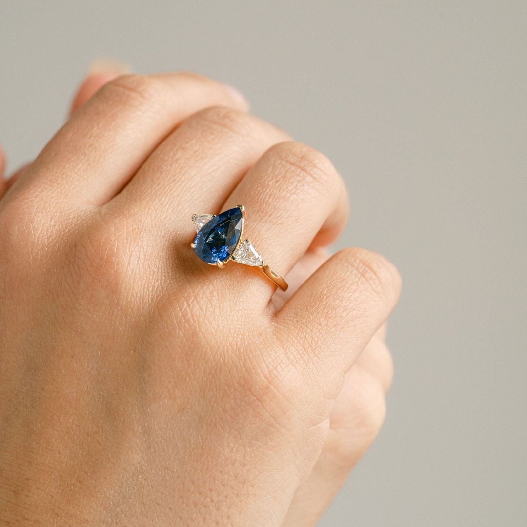 Pear Shape Blue Sapphire With Shield Shape Diamond Accents