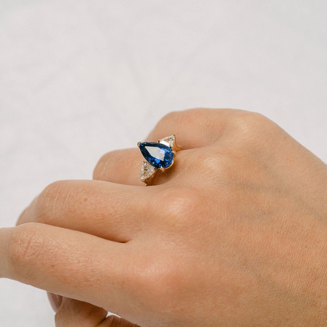 Pear Shape Blue Sapphire With Shield Shape Diamond Accents