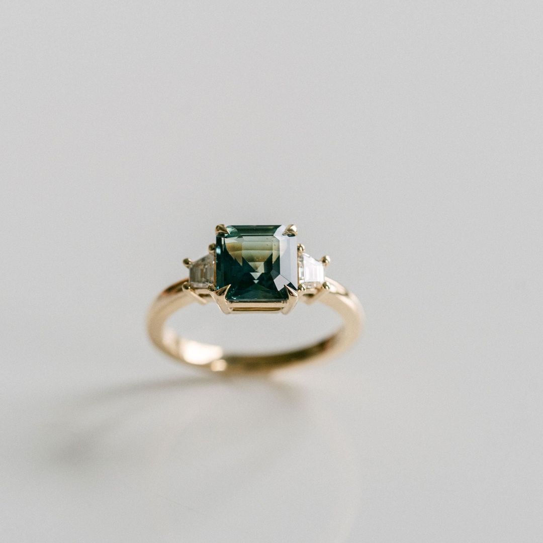 Square Emerald Cut Blue-Green Sapphire with Step Cut Trapezoid Diamond Accents