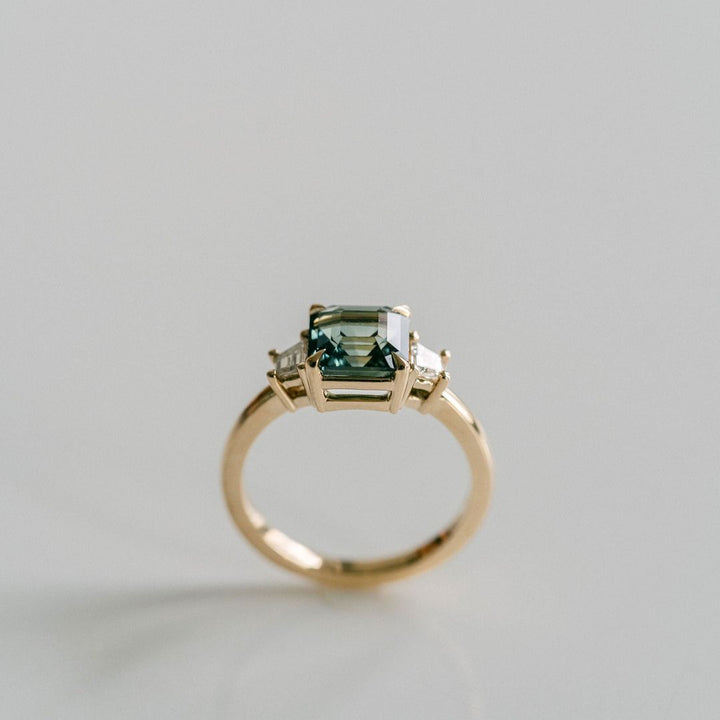 Square Emerald Cut Blue-Green Sapphire with Step Cut Trapezoid Diamond Accents