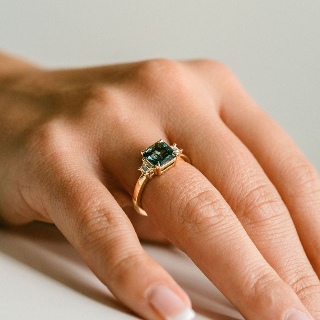 Square Emerald Cut Blue-Green Sapphire with Step Cut Trapezoid Diamond Accents