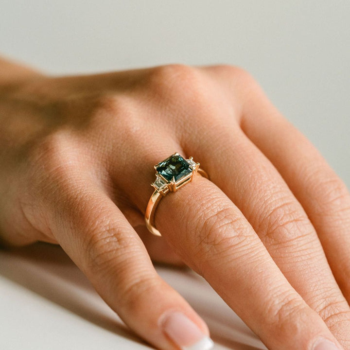 Square Emerald Cut Blue-Green Sapphire with Step Cut Trapezoid Diamond Accents