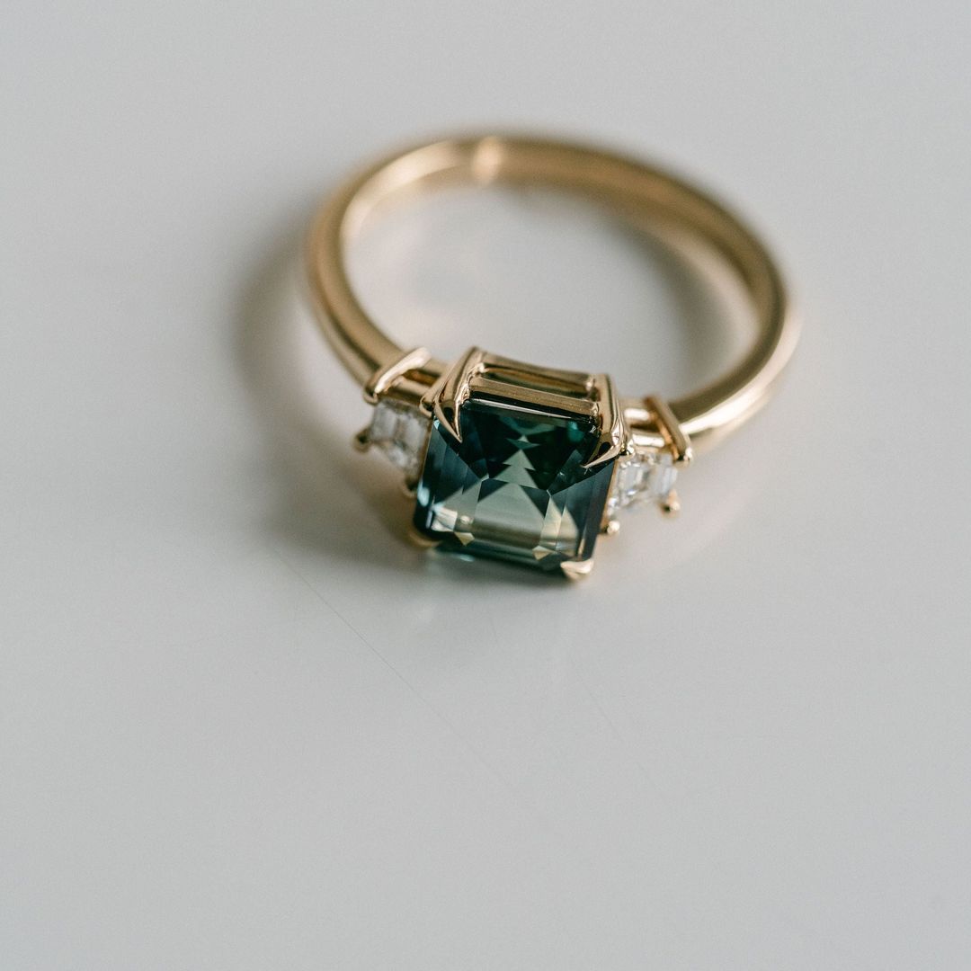 Square Emerald Cut Blue-Green Sapphire with Step Cut Trapezoid Diamond Accents