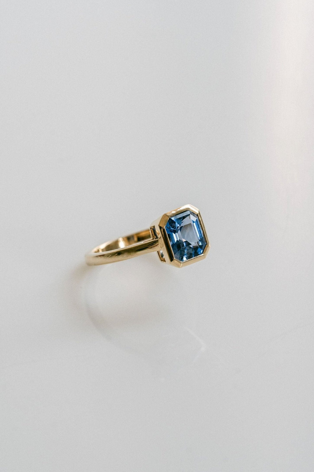Square Emerald Cut Blue Sapphire Breeze Bezel Ring