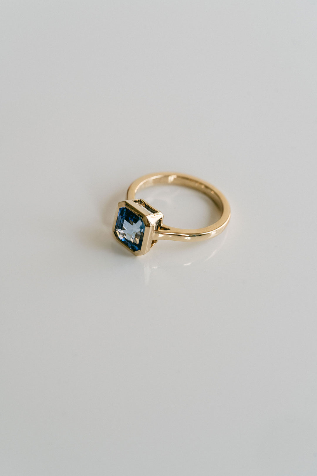 Square Emerald Cut Blue Sapphire Breeze Bezel Ring