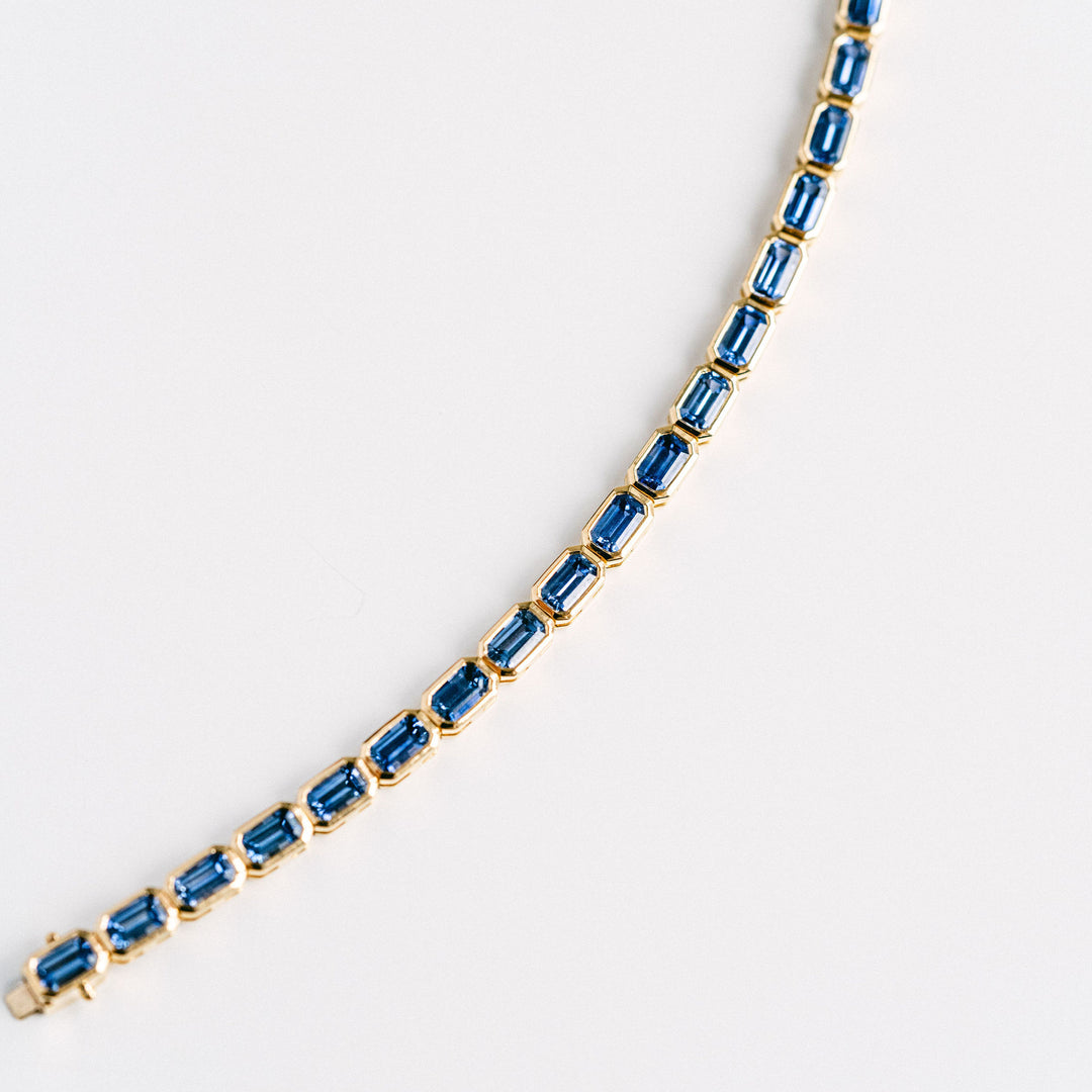 Emerald Cut Blue Sapphire East-West Bezel Tennis Bracelet